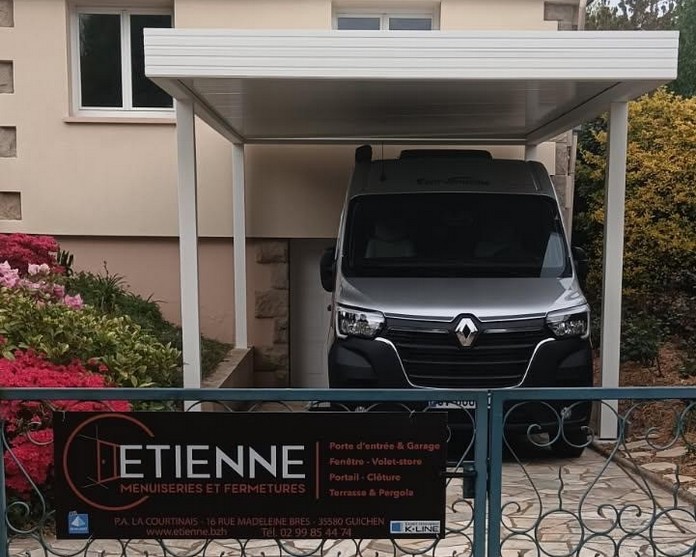 Carport en aluminium blanc installé devant un garage